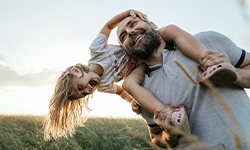 man holding little girl on shoulders